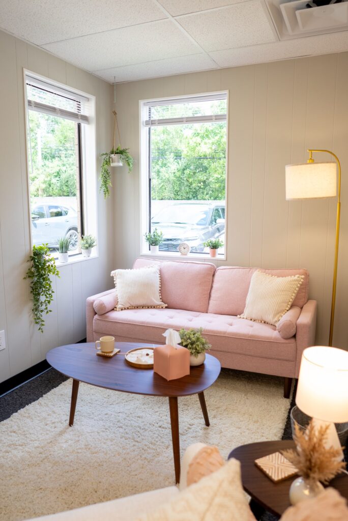 pink couch in a private office at the practice collective with a warm and cozy environment